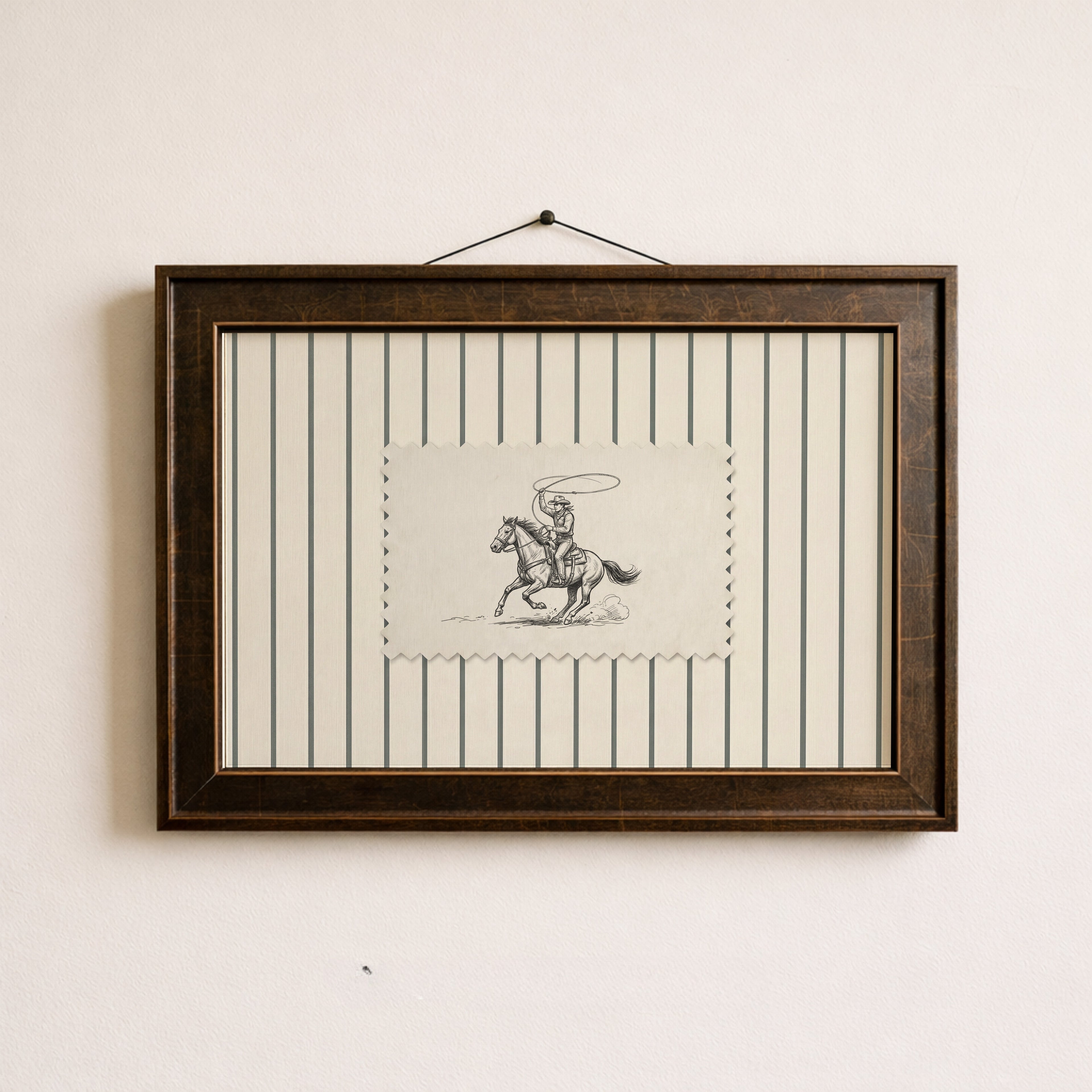 a framed artwork of a cowboy riding a horse, with a black and white illustration of the cowboy and the horse.
