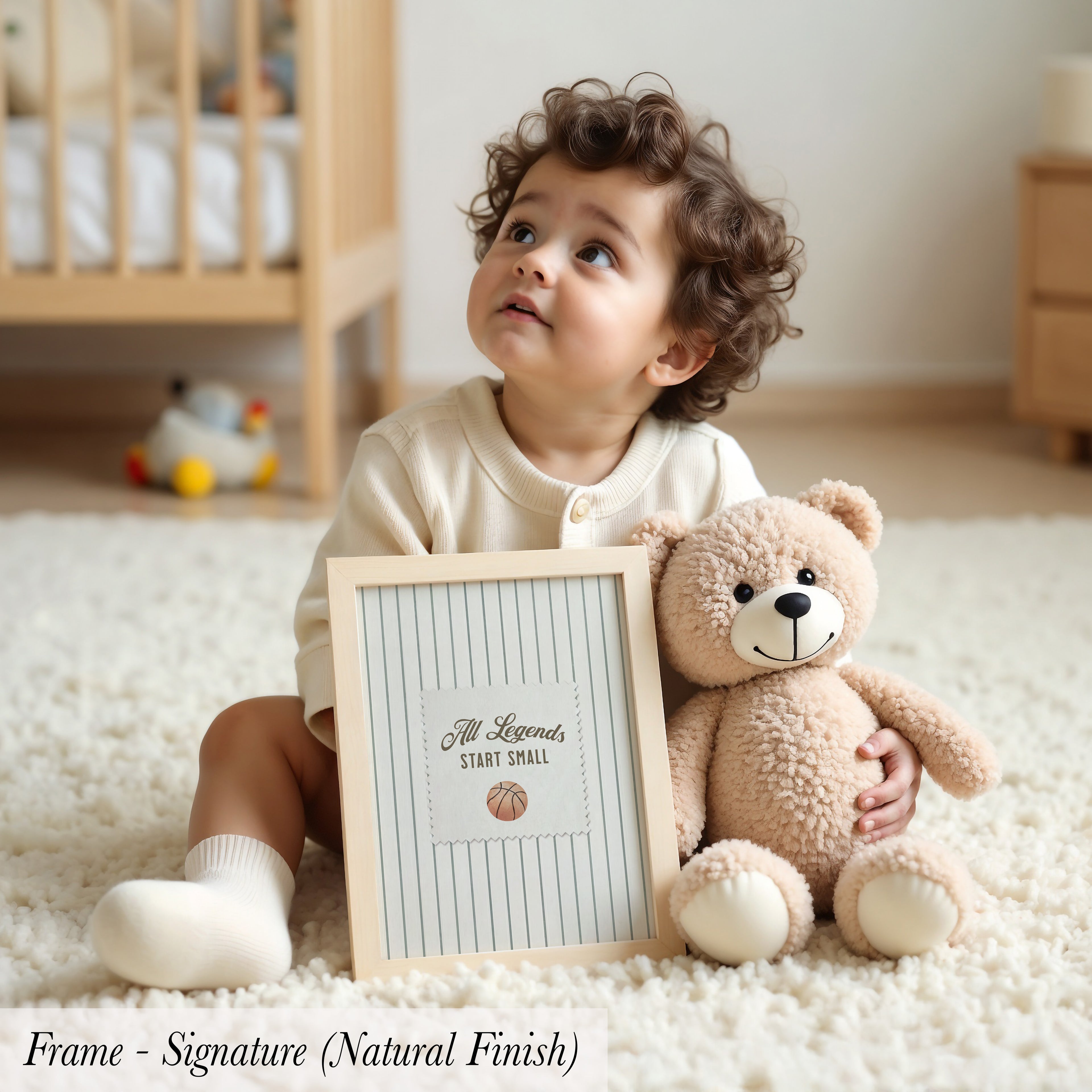 A young child sits on the floor, holding a picture frame with a teddy bear inside.