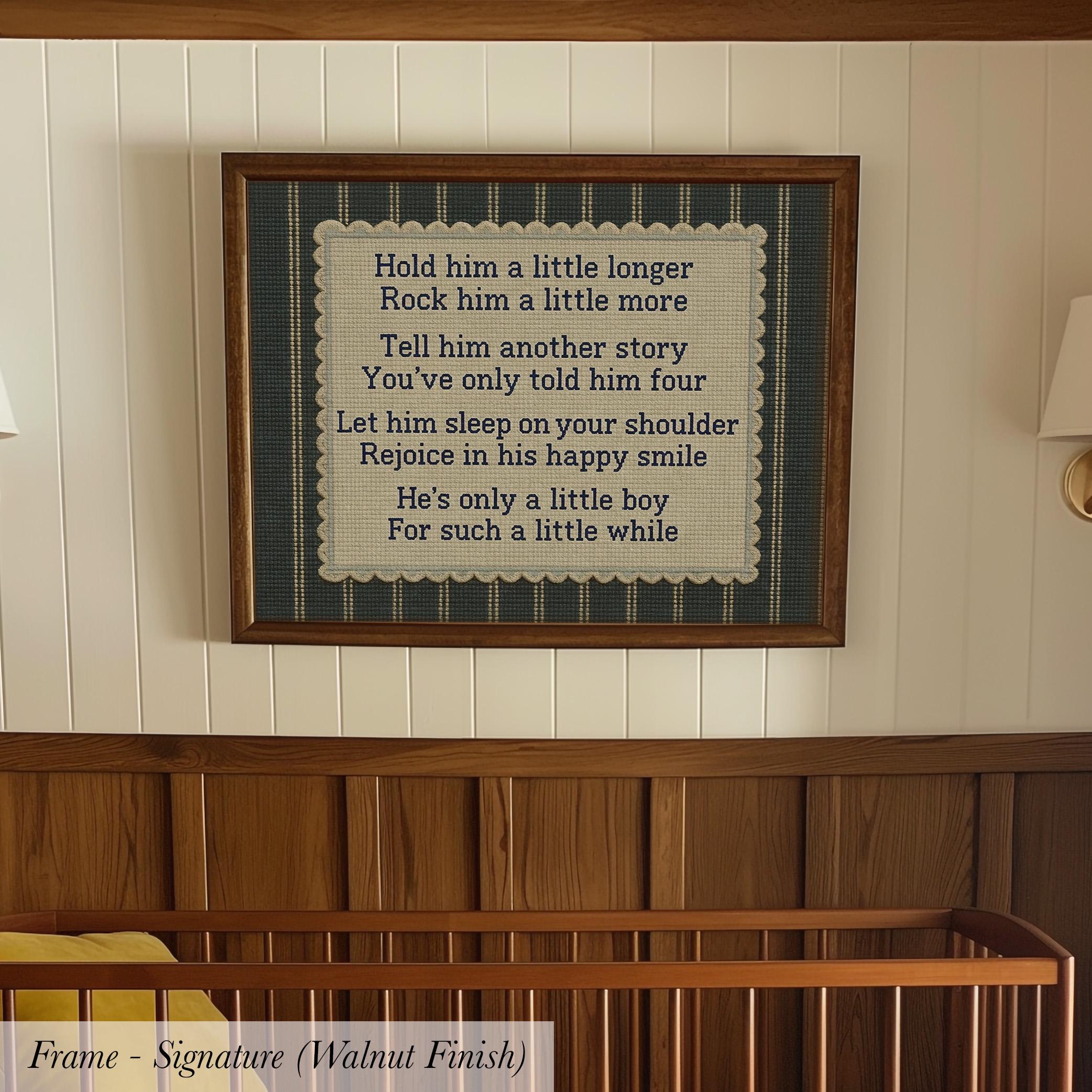 a framed nursery wall with a poem or lyrics about a little boy, including a message about holding him longer, telling him a story, letting him sleep on his shoulder, and cheering him on.