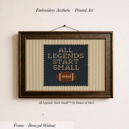 a framed embroidered piece of art with the text "ALL LEGENDS START SMALL" and a football motif.