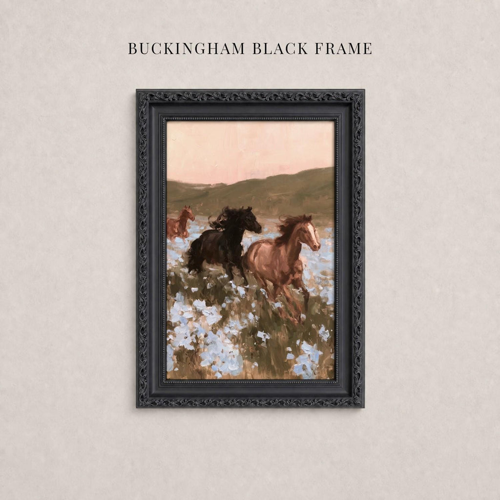 A framed painting depicting three horses galloping through a field of flowers.