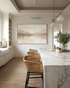a modern kitchen with a marble countertop, wicker chairs, and a large painting on the wall above the counter.