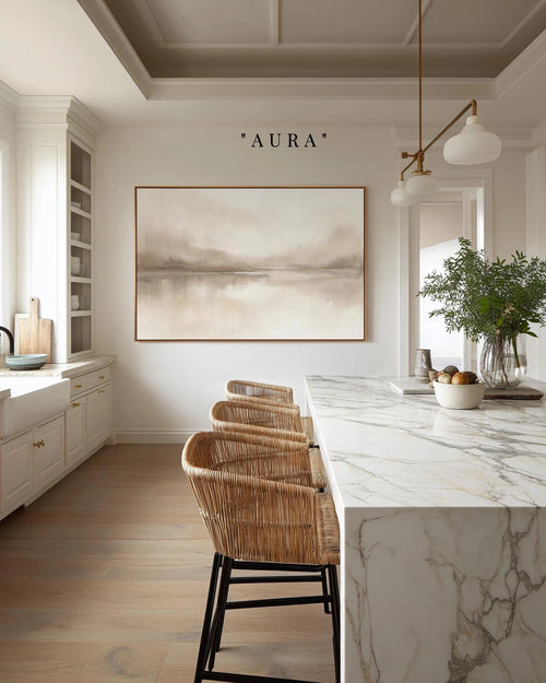 a modern kitchen with a marble countertop, wicker chairs, and a large painting on the wall above the counter.
