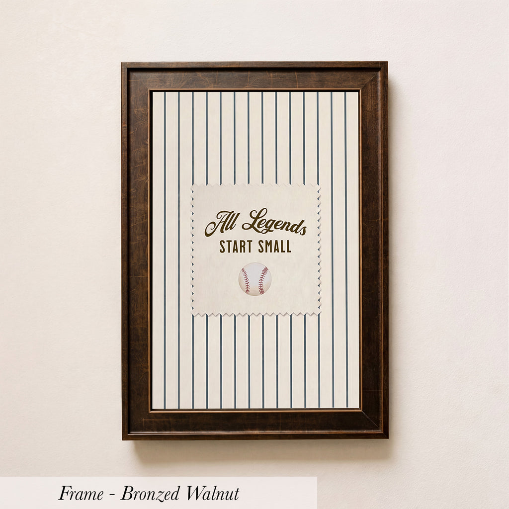 A framed picture with a baseball and the text "All Legends Start Small" on it, hanging on a wall.