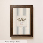 A framed picture with a baseball and the text "All Legends Start Small" on it, hanging on a wall.