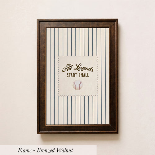 A framed picture with a baseball and the text "All Legends Start Small" on it, hanging on a wall.