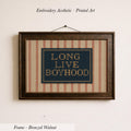 a framed embroidered piece of art with the text "LONG LIVE BOYHOOD" displayed on it.