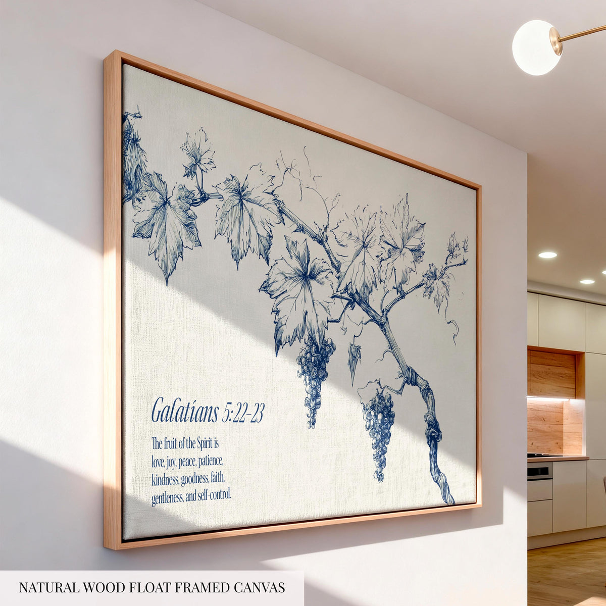 a large framed canvas depicting a blue and white illustration of a grape vine with leaves and grapes. The text below the illustration reads "Galatians 5:22-23".