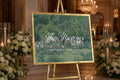 a large sign with a floral design and the text "The Hastings" and "SEPTEMBER 12TH 2026" displayed on it, placed in a room with floral arrangements and candles.
