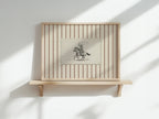 a wooden shelf with a framed picture of a cowboy on horseback.