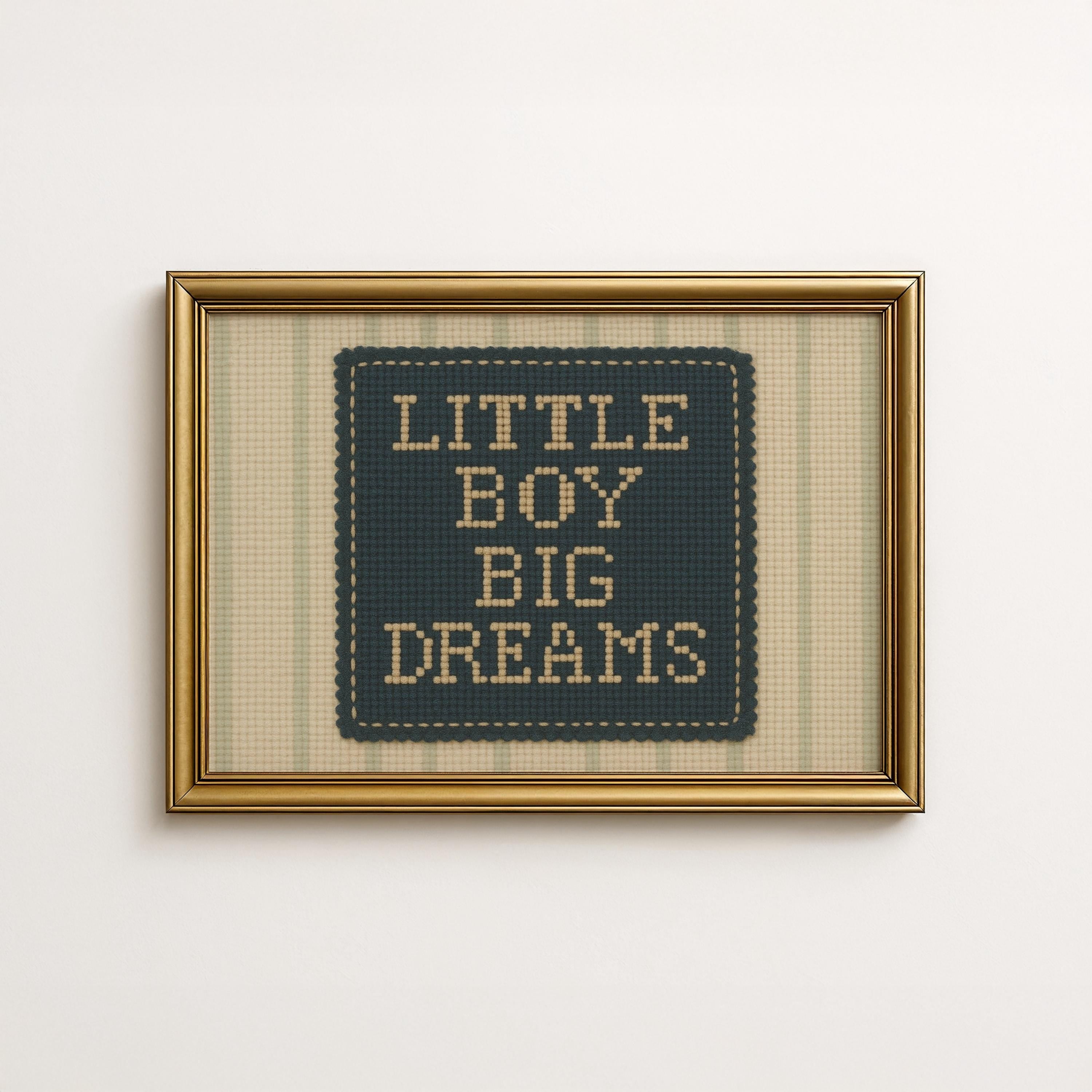 a framed cross-stitch design with the text "LITTLE BOY BIG DREAMS" displayed on it.