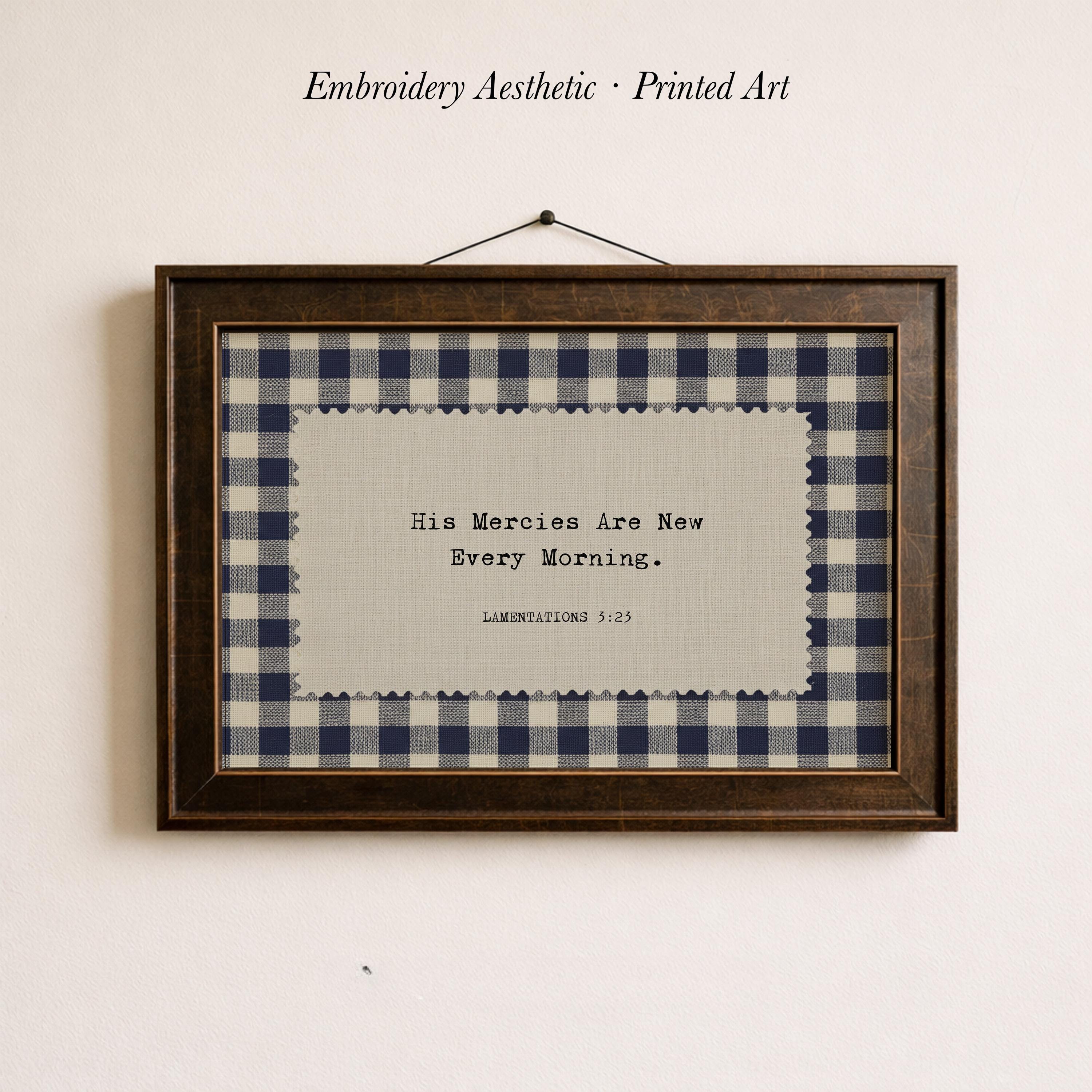 The image is a framed print with a black and white checkered pattern and a quote about mercies.