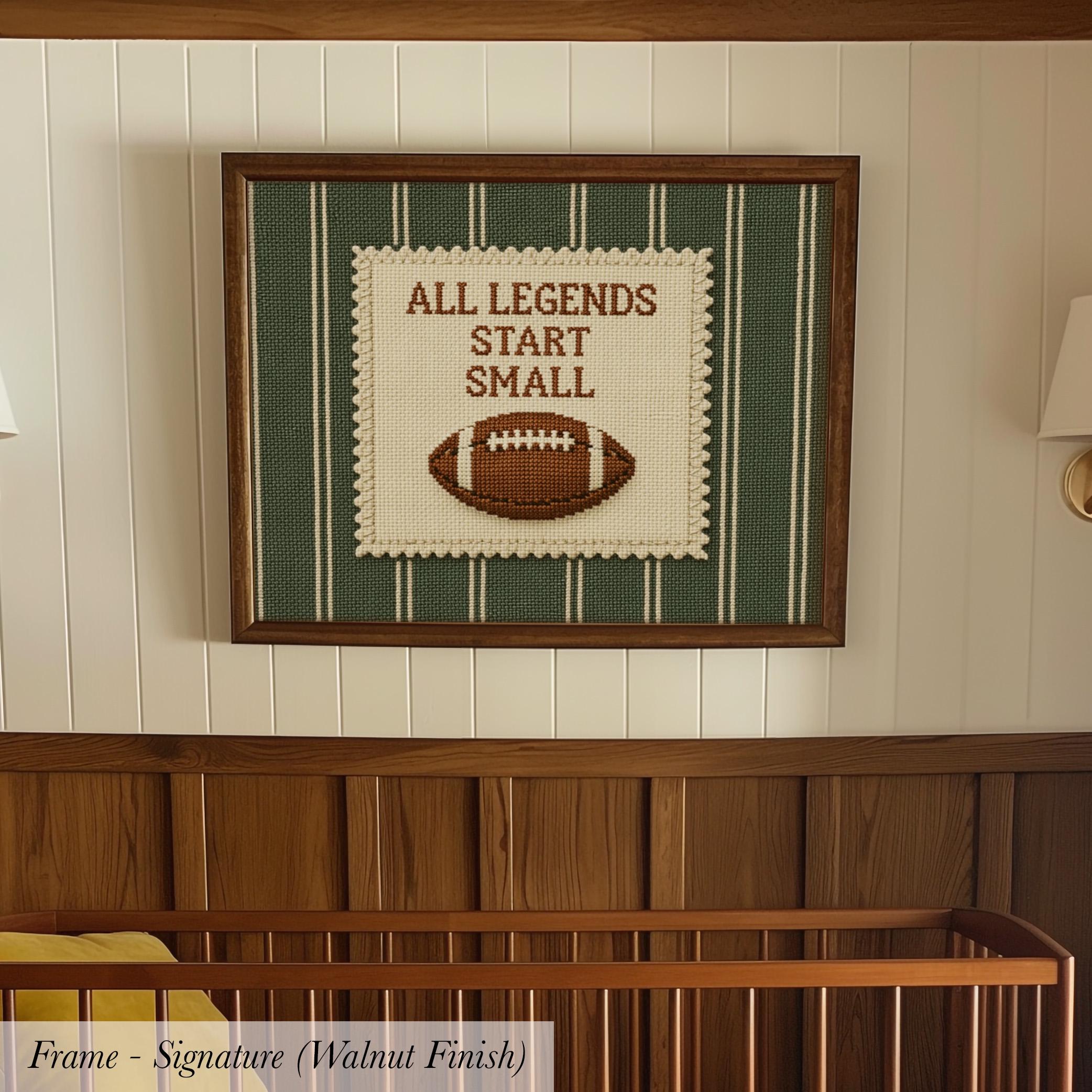 A framed wall hanging with the text "ALL LEGENDS START SMALL" and a football image, hanging above a wooden crib.