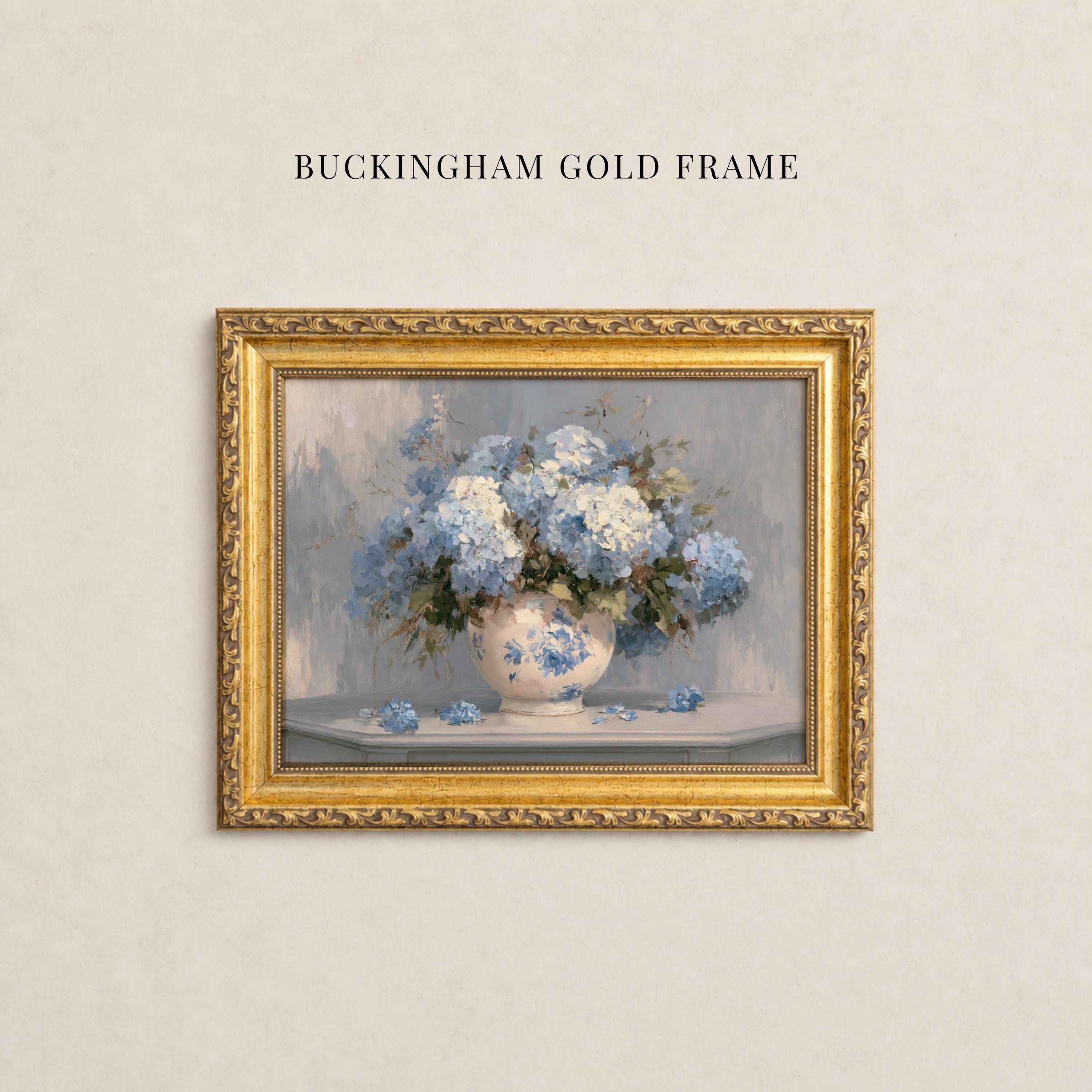 May include: A rectangular wall art piece titled BUCKINGHAM GOLD FRAME featuring a painting of a white ceramic vase filled with blue and white hydrangea flowers, enclosed in an ornate, textured gold-colored frame with intricate carved detailing.