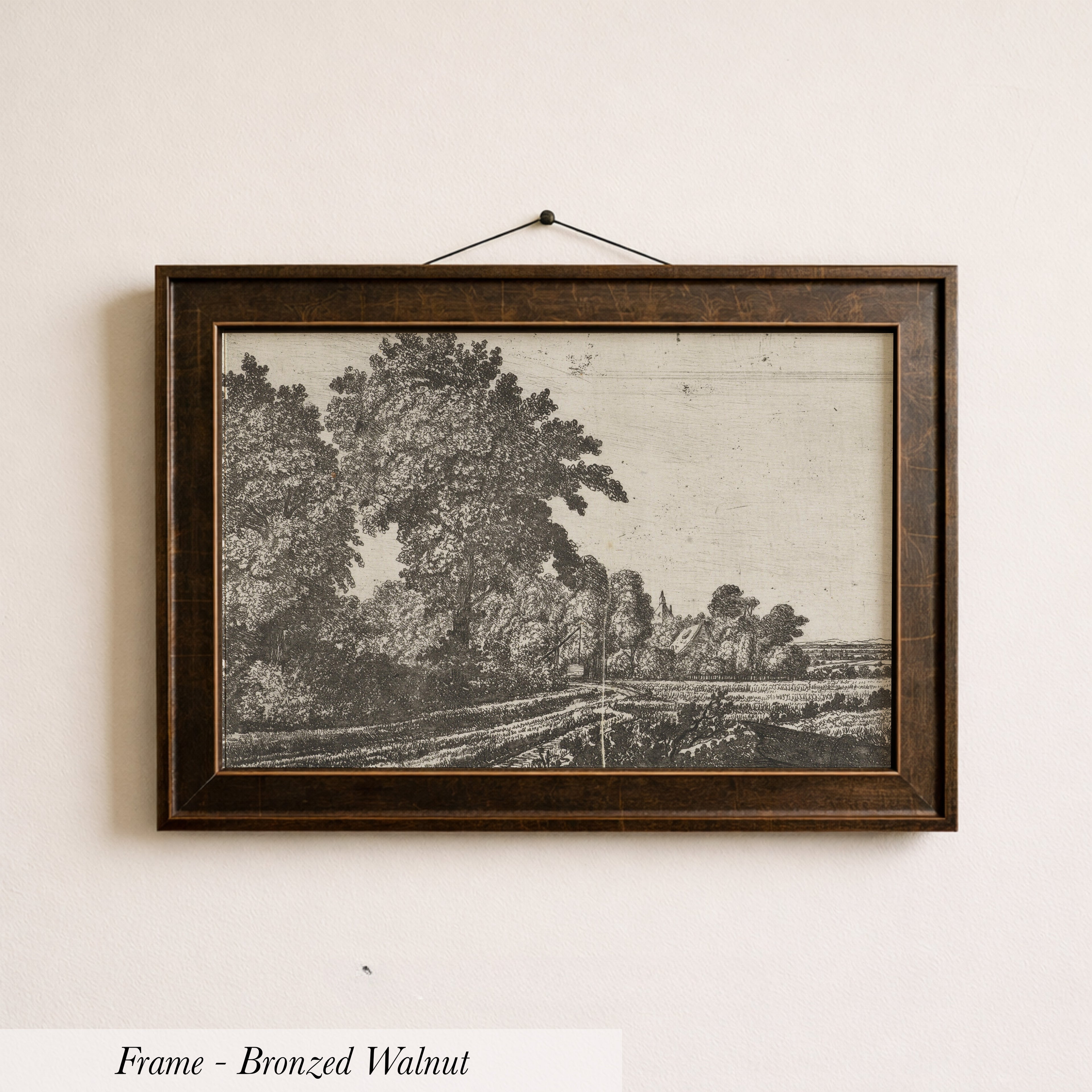 The image is a framed bronze-colored painting depicting a landscape with trees and a road.