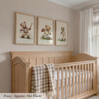 A wooden crib with three framed teddy bear illustrations on the wall above it.