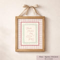 A framed print with a bow on top, displaying the text "Thank Heaven for Little Girls" in a pink and green checkered pattern.