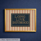 a framed piece of artwork with the text "LONG LIVE BOYHOOD" displayed on it.