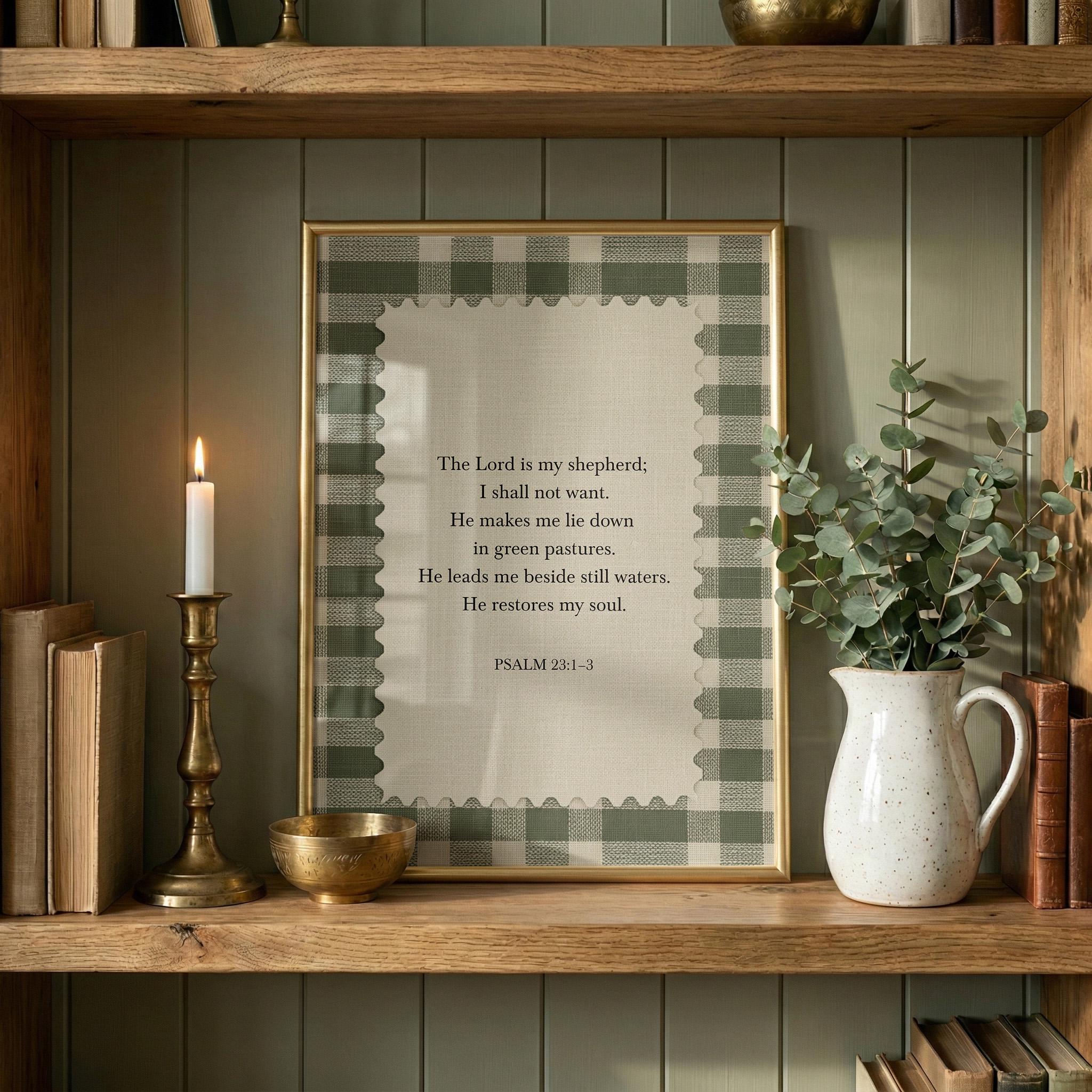 A framed Bible verse, "The Lord is my shepherd," is displayed on a wooden shelf, accompanied by a lit candle, a white vase with greenery, and a small bowl.