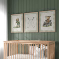 a nursery with a wooden crib, three framed pictures of teddy bears, and a golf cart, all set against a green wall.