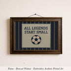 The image is a framed embroidery depicting a soccer ball with the text "ALL LEGENDS START SMALL" on it.