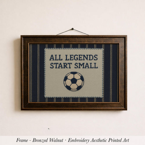 The image is a framed embroidery depicting a soccer ball with the text "ALL LEGENDS START SMALL" on it.