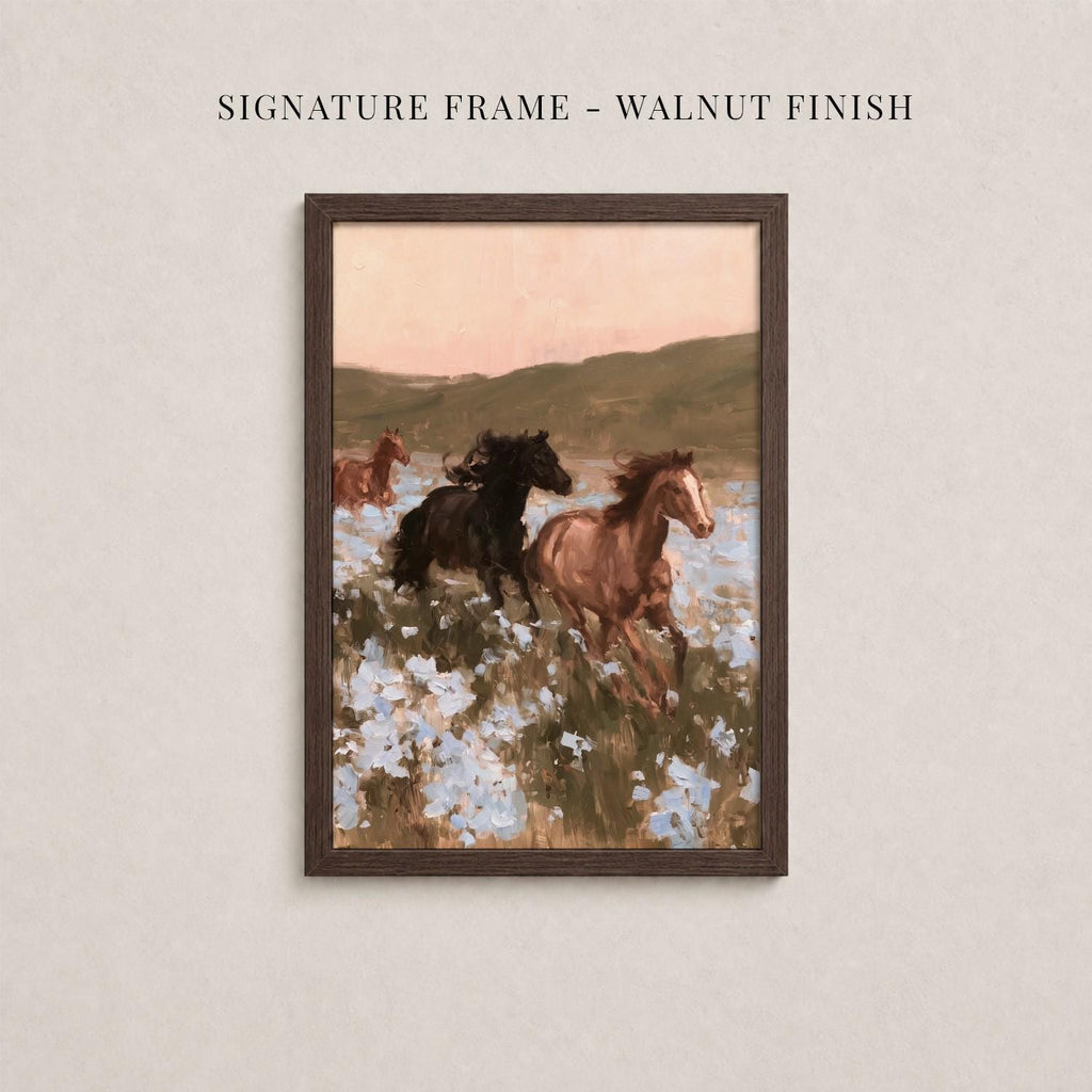 The image is a framed painting depicting a field with horses running through it, surrounded by flowers.