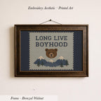 The image is a framed embroidery depicting a bear with mountains in the background, accompanied by the text "LONG LIVE BOYHOOD".