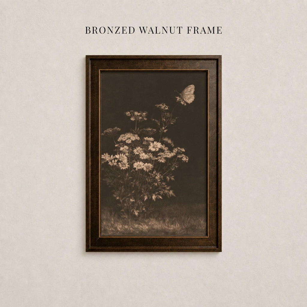 The image is a framed photograph of a flower with a butterfly in flight, mounted on a wall.