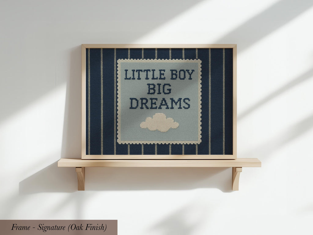 a framed piece of art with the text "LITTLE BOY BIG DREAMS" displayed on it.