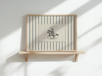 a wooden shelf with a framed picture of a cowboy on a horse.