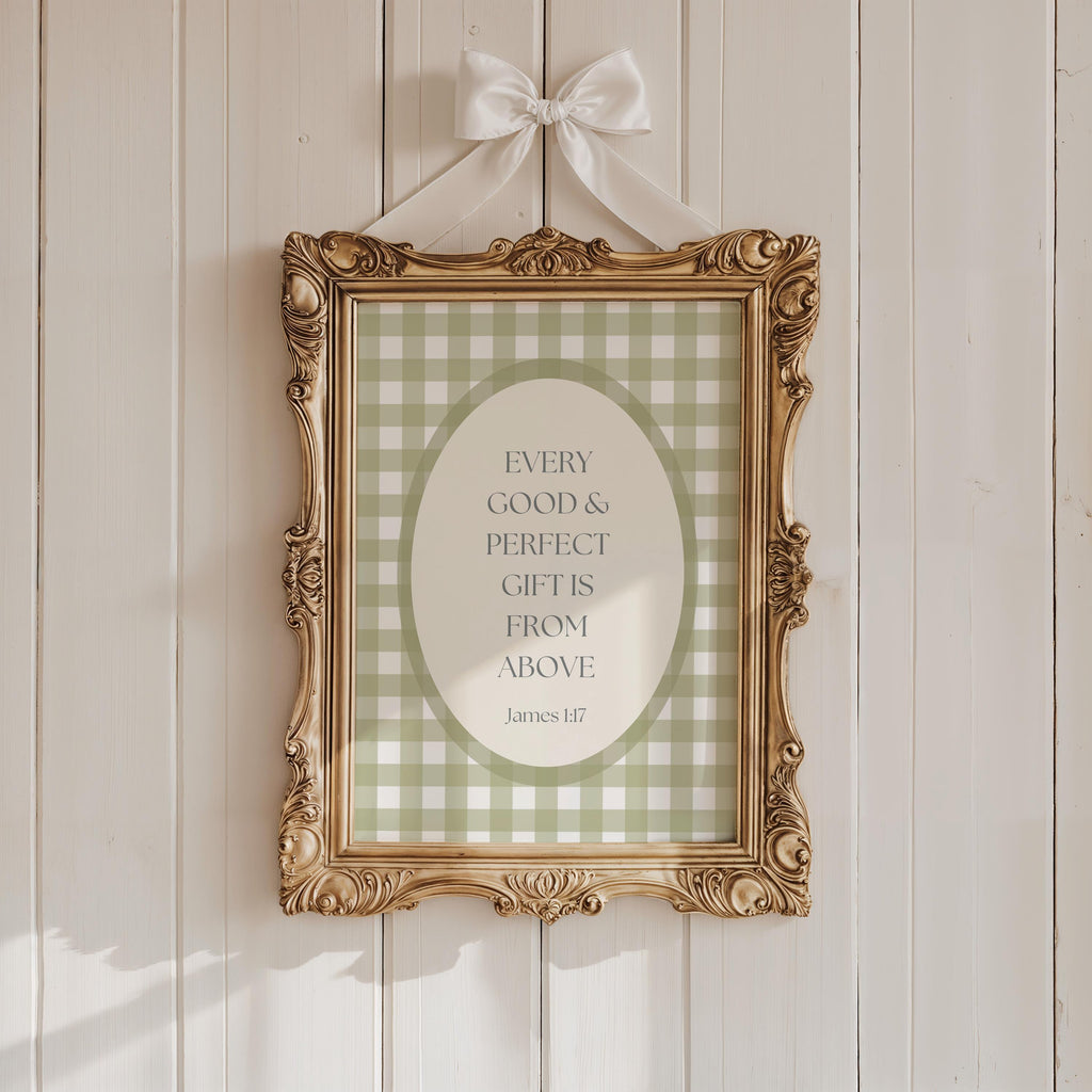 a gold-framed picture hanging on a white wooden wall. The picture has a green and white checkered pattern and contains a quote about gifts from above.