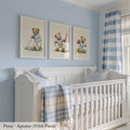 A nursery room with a white crib and three framed pictures of teddy bears on the wall above it.
