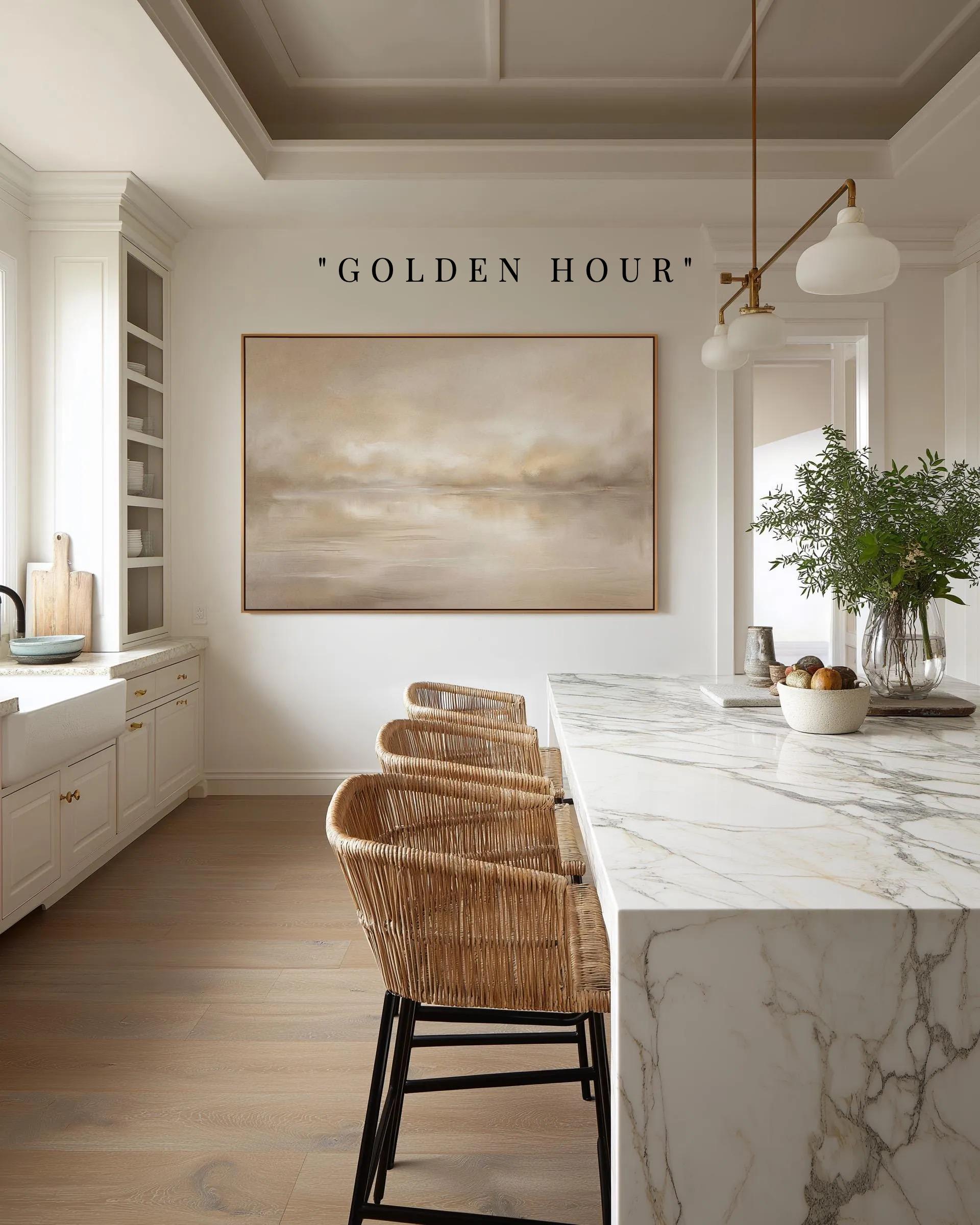 a modern kitchen with a marble countertop, wicker chairs, and a large painting on the wall. The painting is titled "Golden Hour".