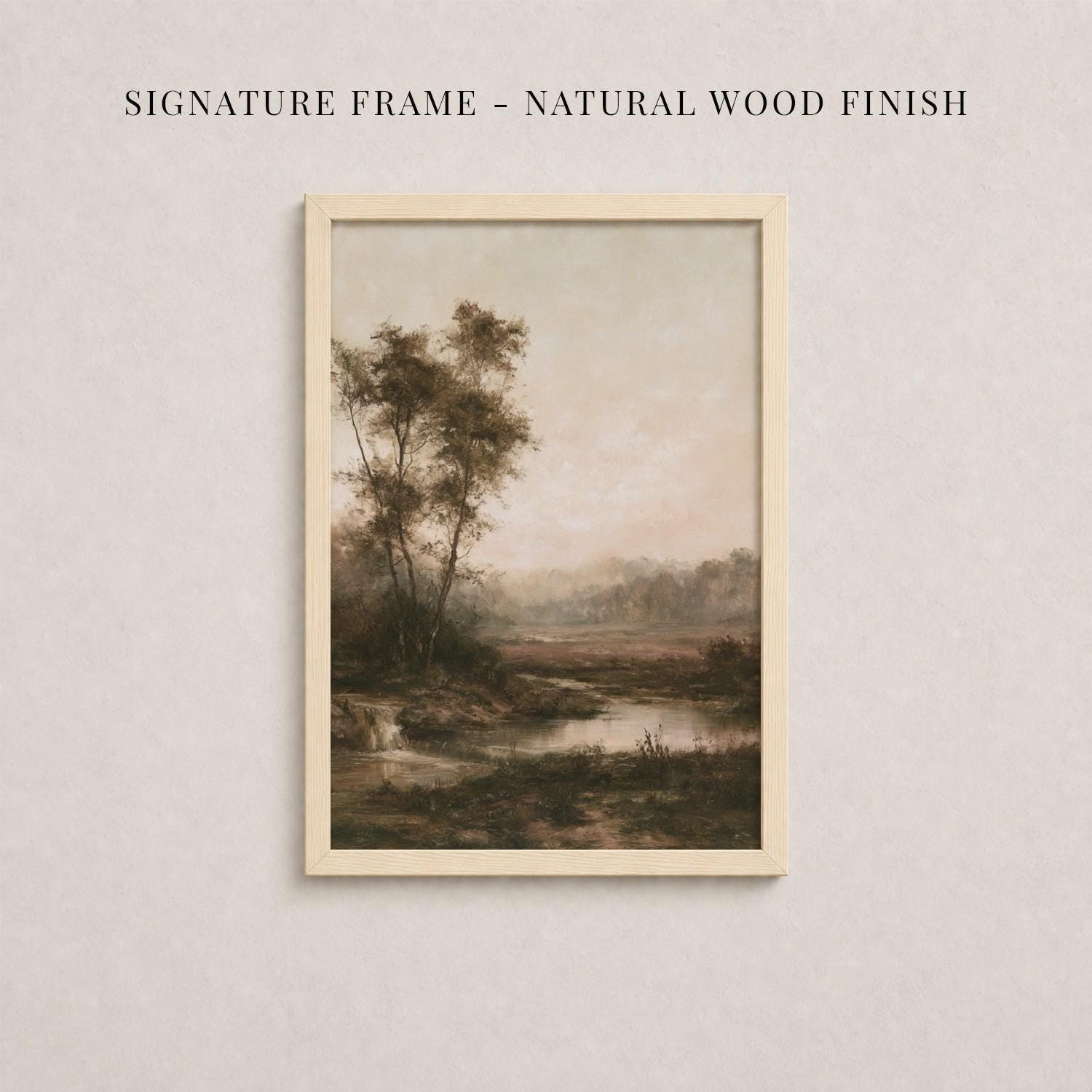 The image is a framed painting depicting a serene landscape with trees, a river, and a hazy sky.