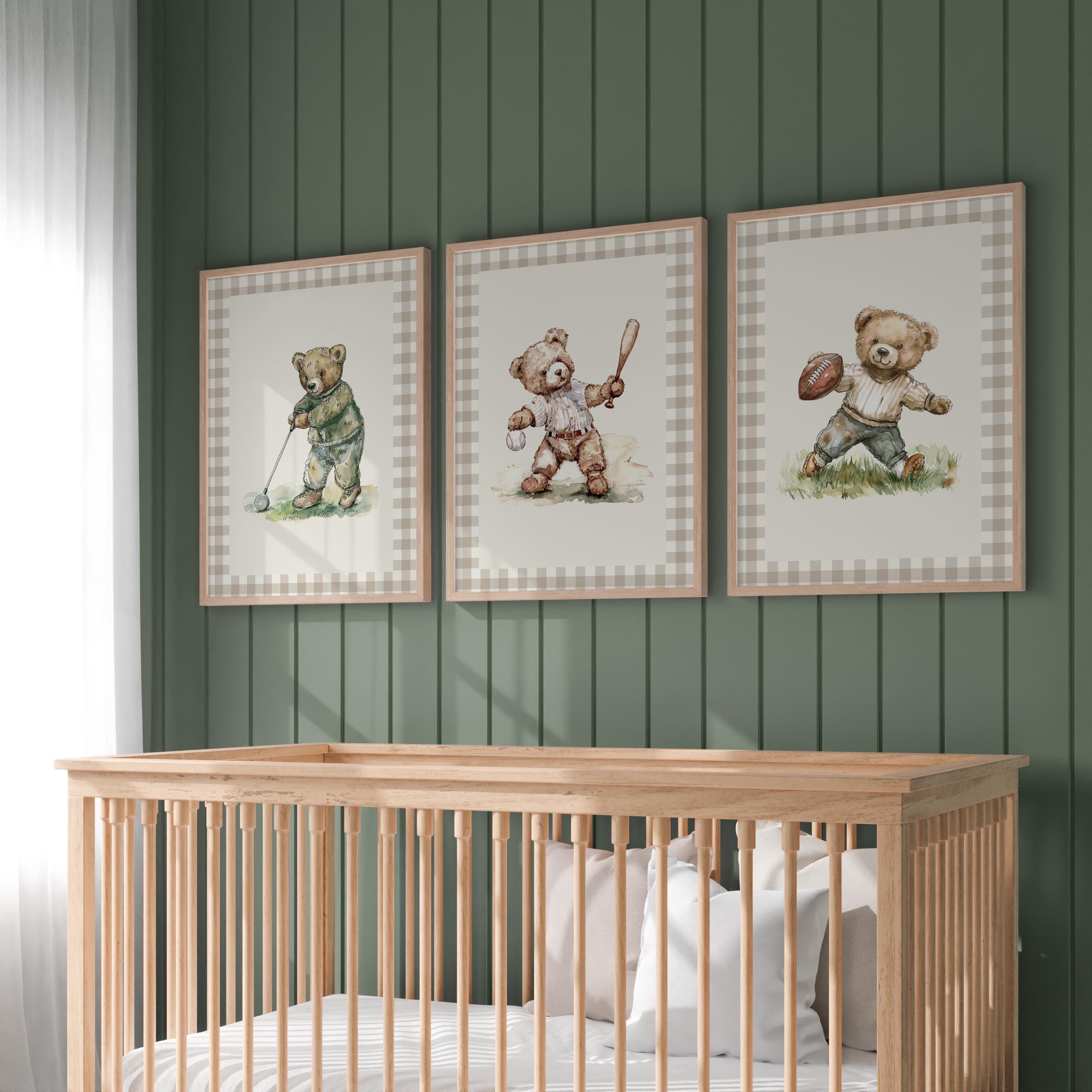 A nursery room with a wooden crib and three framed pictures of teddy bears on the wall above it.