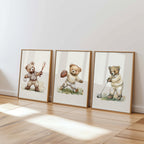 three framed pictures of teddy bears, each depicting a different activity - one holding a baseball, another holding a football, and the third holding a golf club.