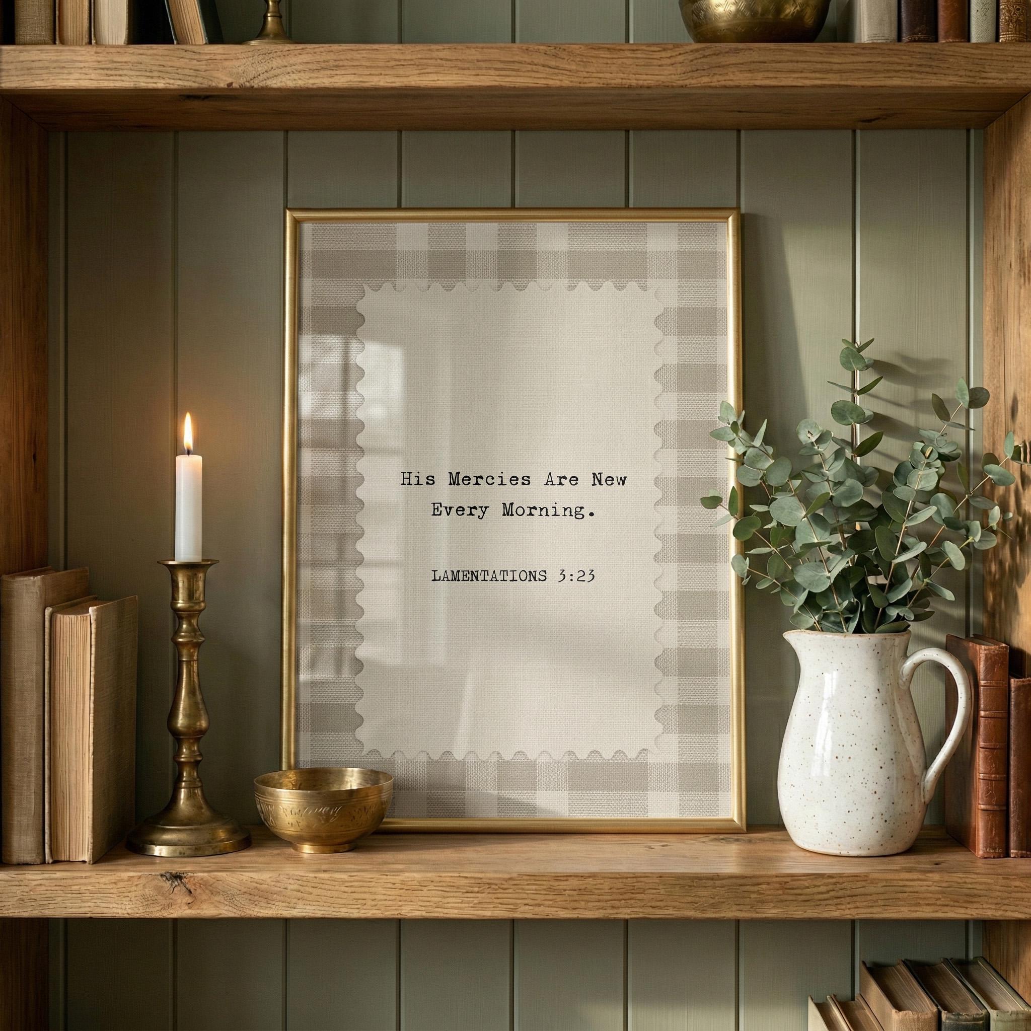 a wooden shelf with a framed quote, a candle, a vase with greenery, and some books.