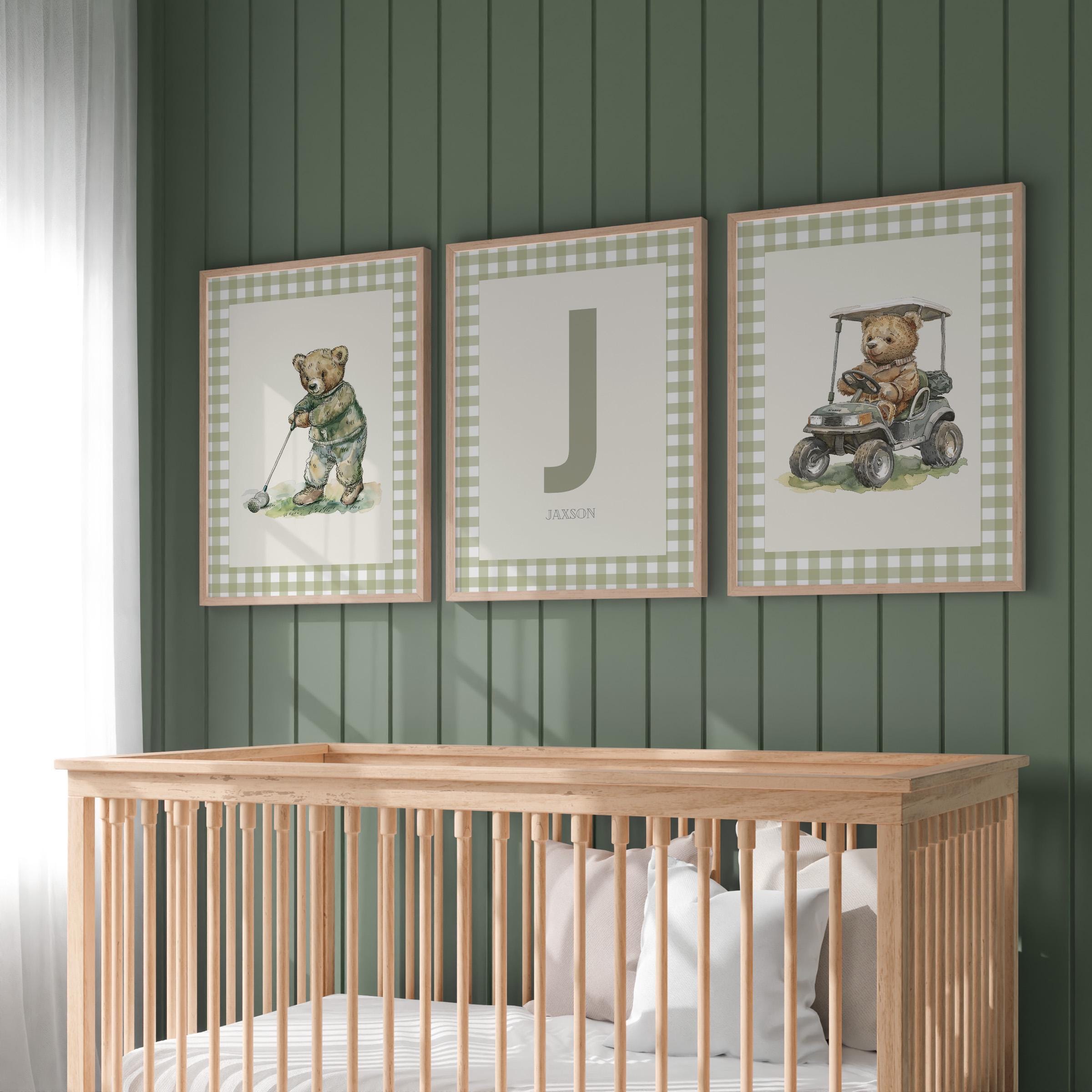 A nursery room with a wooden crib and three framed wall art pieces depicting teddy bears playing golf.
