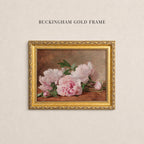 May include: A rectangular ornate gold frame containing a painting of light pink peony flowers with green leaves against a dark brown background. The text BUCKINGHAM GOLD FRAME is printed in black capital letters above the framed artwork.