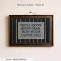 a framed embroidered piece of art with the text "YOU'LL NEVER KNOW DEAR HOW MUCH I LOVE YOU" on it.