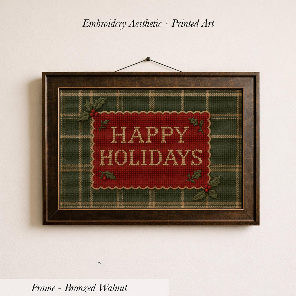A framed embroidered design with the text "HAPPY HOLIDAYS" on a green and red plaid background.