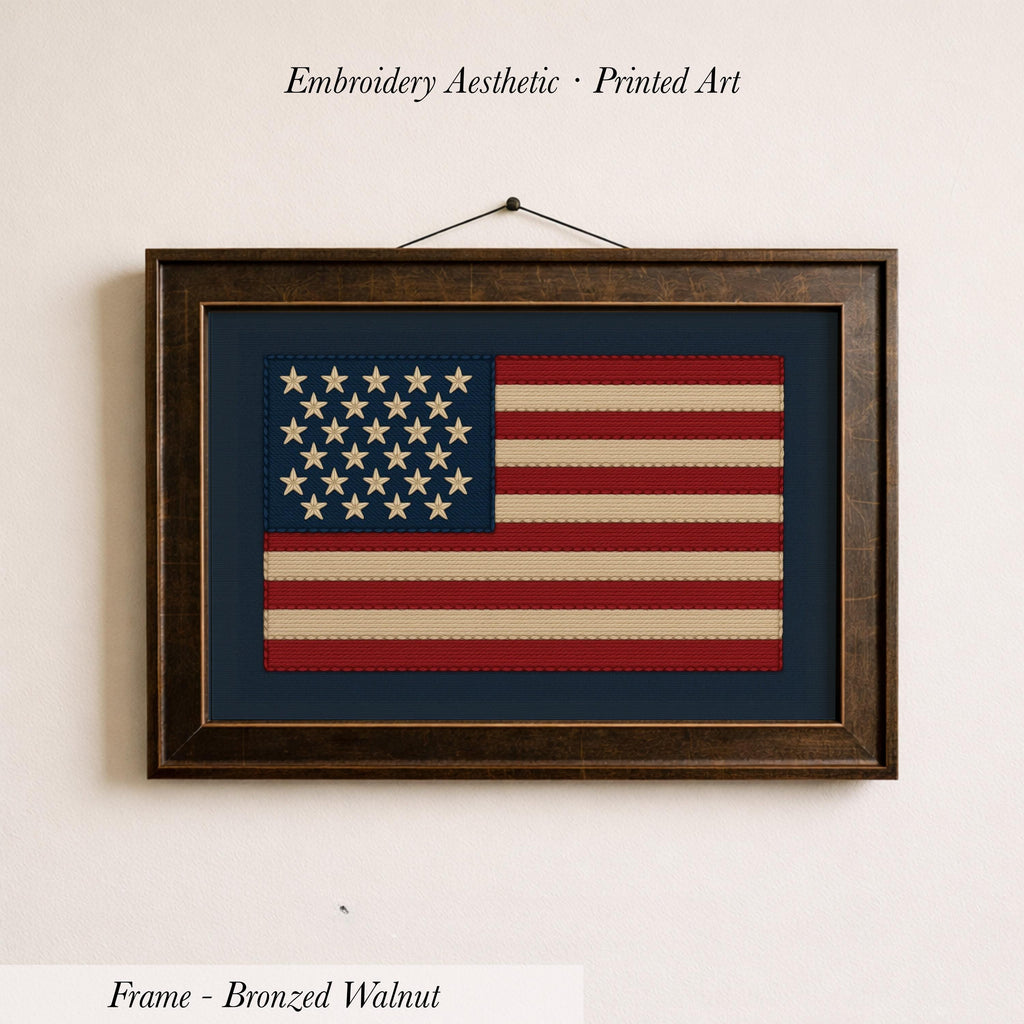 a framed embroidered American flag on a wall.