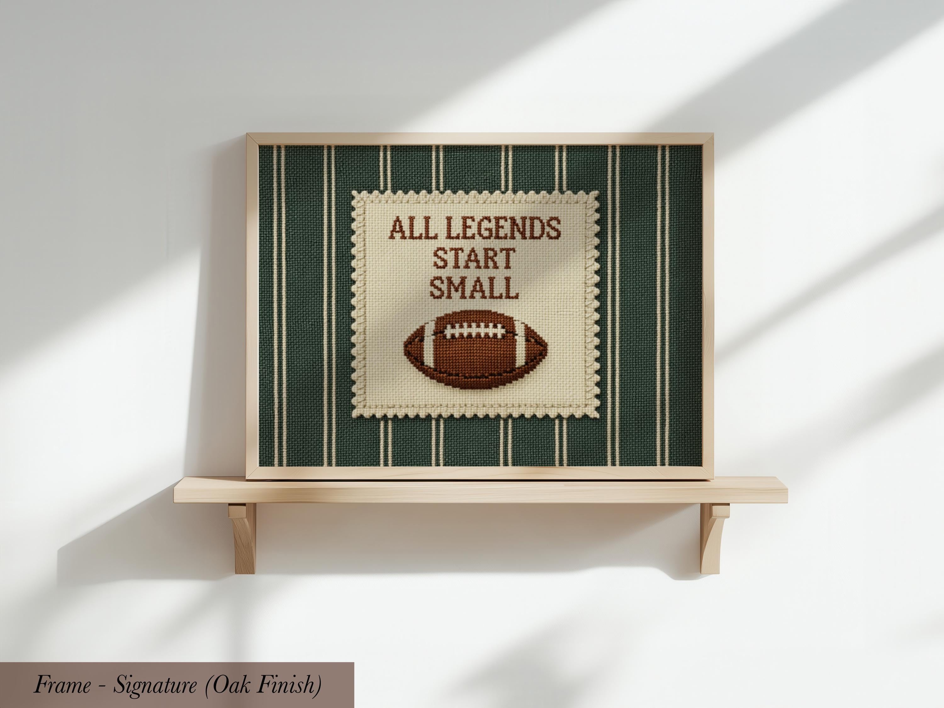 a framed poster with the text "ALL LEGENDS START SMALL" and an embroidered football on a green and white background.