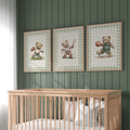 A nursery room with a wooden crib and three framed pictures of teddy bears on the wall above it.