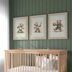 A nursery room with a wooden crib and three framed pictures of teddy bears on the wall above it.