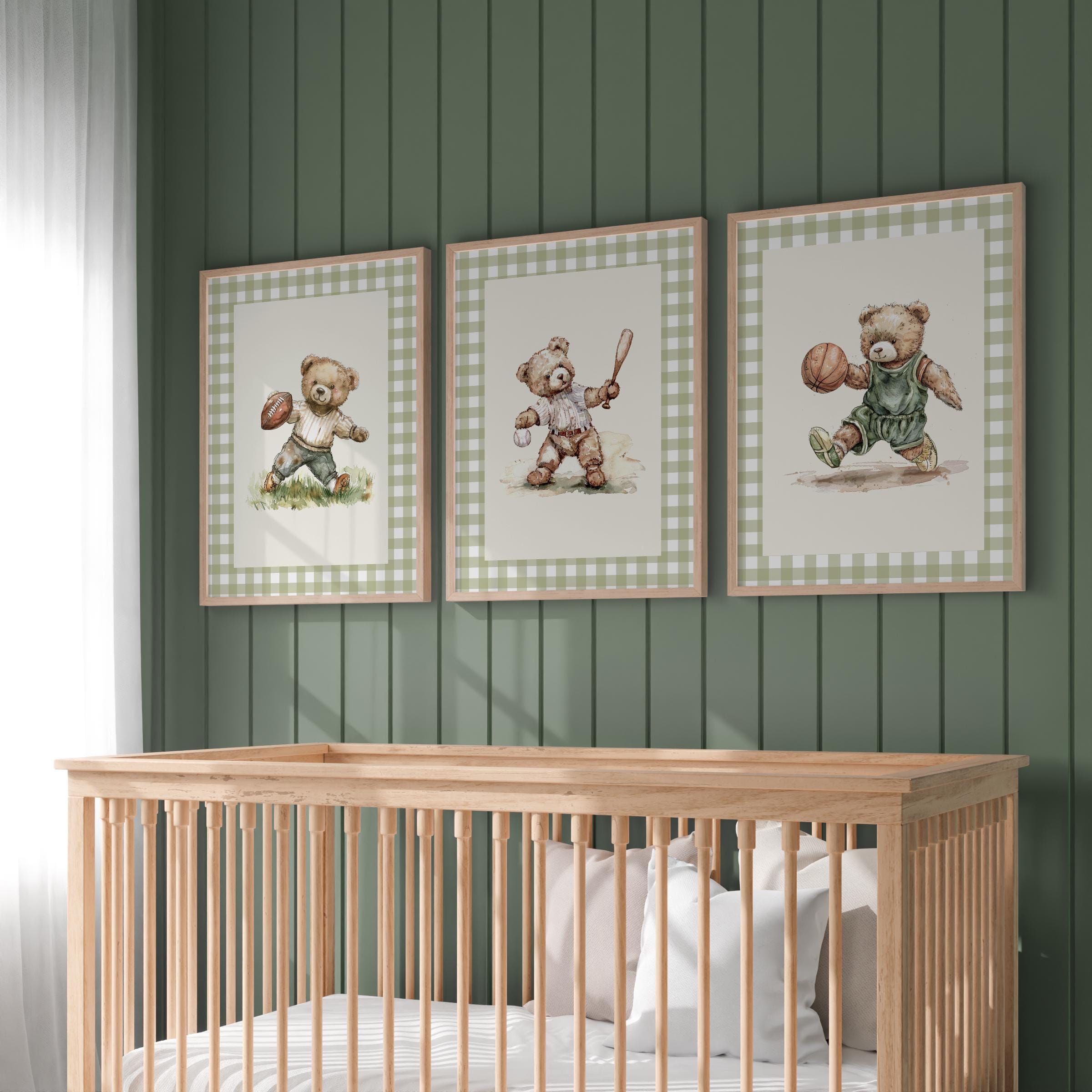 A nursery room with a wooden crib and three framed pictures of teddy bears on the wall above it.