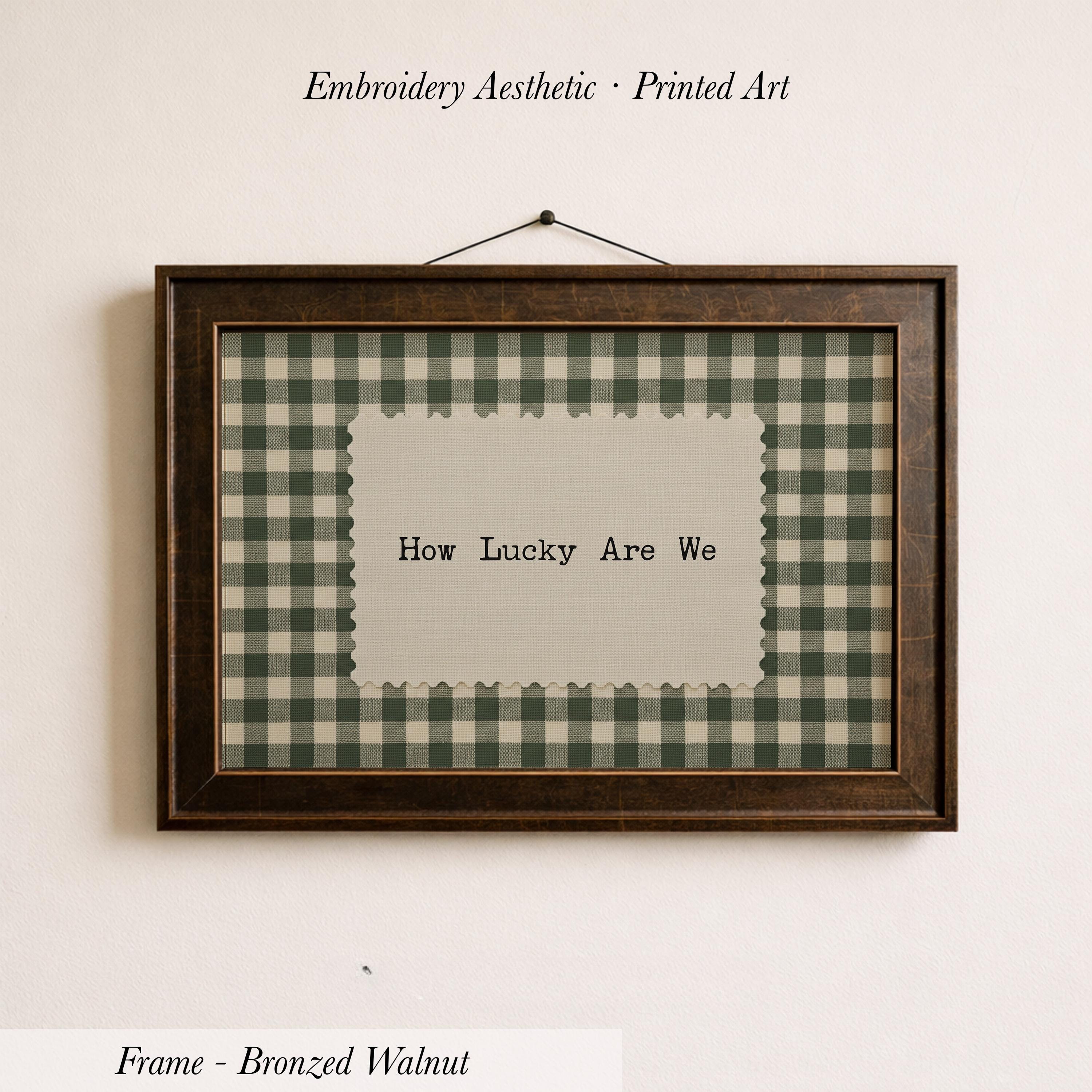 The image is a framed print with the text "How Lucky Are We" displayed on it.