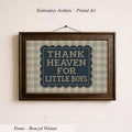 a framed embroidered print with the text "THANK HEAVEN FOR LITTLE BOYS" on it.