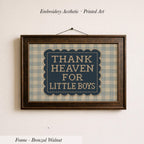a framed embroidered print with the text "THANK HEAVEN FOR LITTLE BOYS" on it.